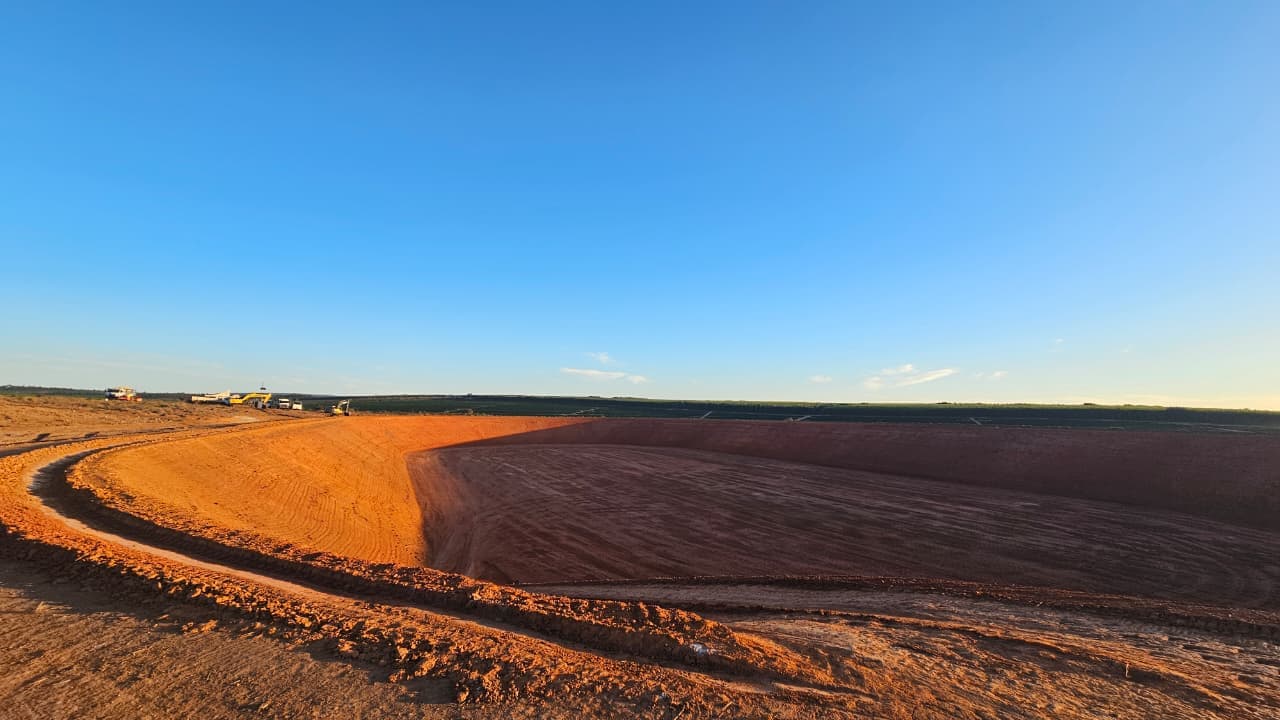 Frente de terraplenagem com escavadeiras operando em reservatório off-stream agrícola — Exxata Agro